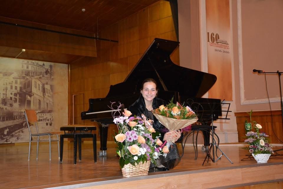 Angela Todorova on stage with flowers after a recital