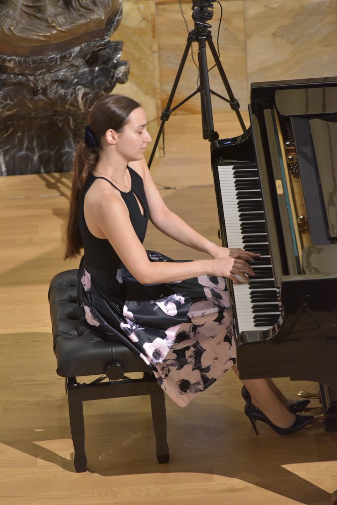 Angela Todorova seated at the grand piano, in profile