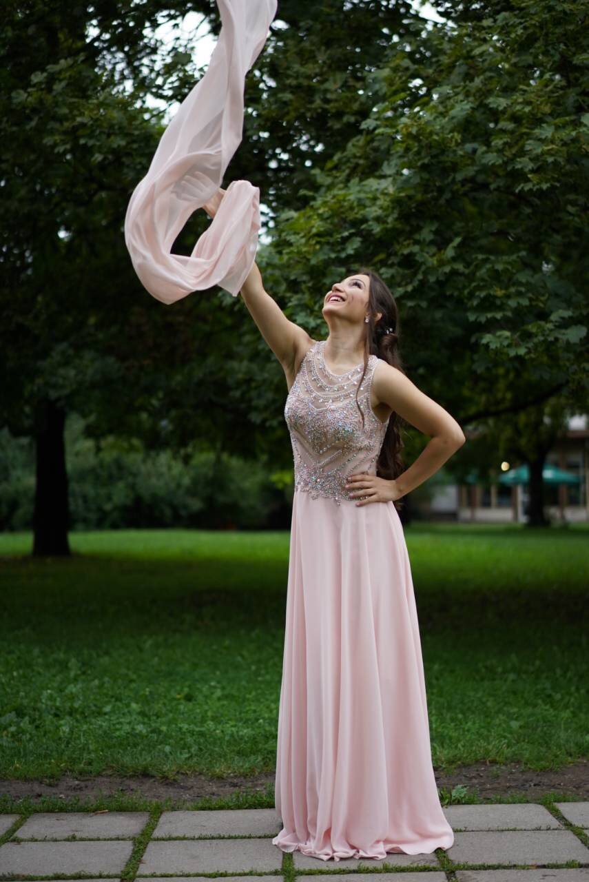 Angela Todorova in a pink gown in a park