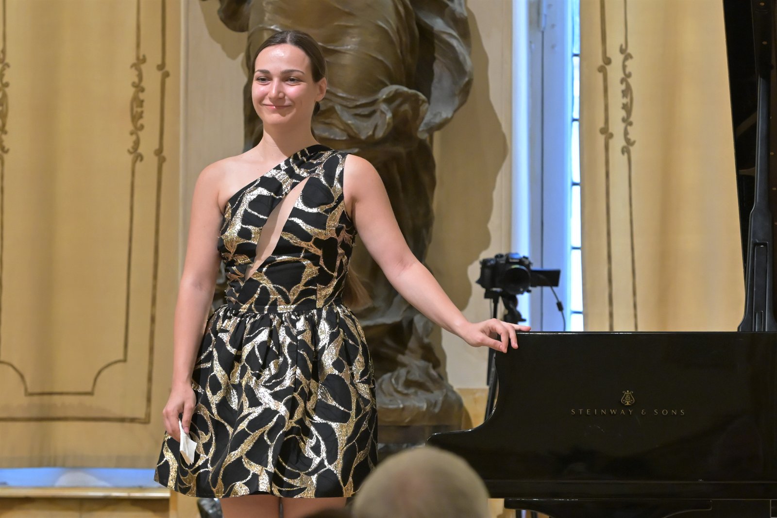 Angela Todorova acknowledging the audience beside a Steinway in Siena