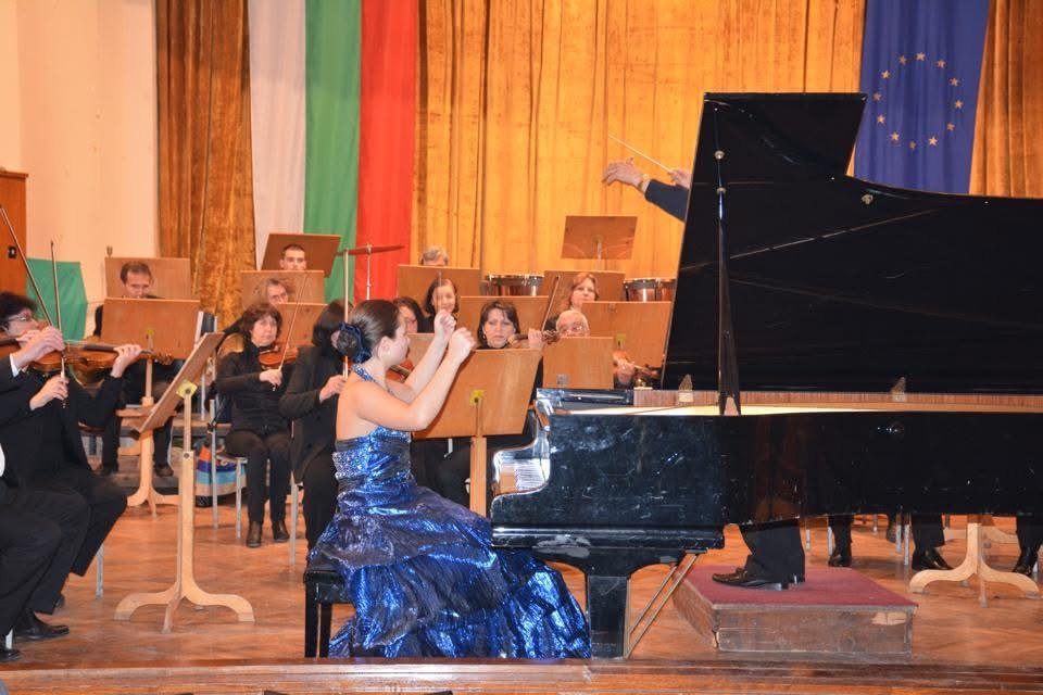 Angela Todorova playing a concerto with orchestra and conductor